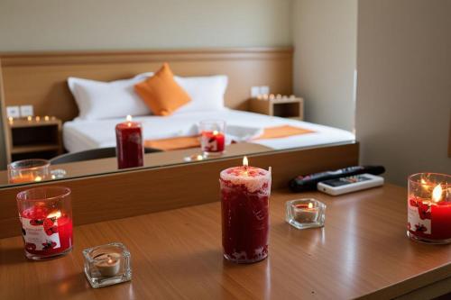 a room with a bed and candles on a table at Hotel Golden Flora in Beni Mellal
