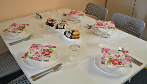 a white table with plates of food on it at Little Bullocks Farm in Takeley