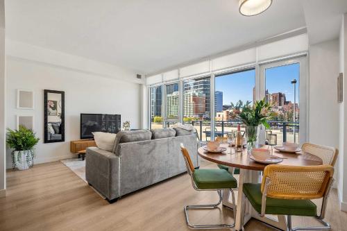 a living room with a couch and a table at Riverside Retreat - FREE Banff Pass, Gym, Parking! in Calgary