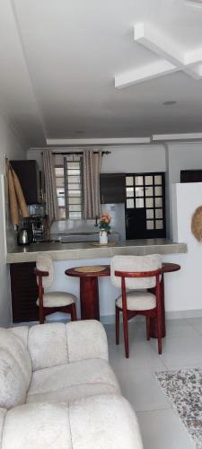 a living room with a couch and a kitchen at Boho Comfort Homes in Diani Beach