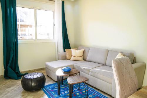 a living room with a couch and a table at Modern 2 bedroom apartment, one with terrace in Marrakech