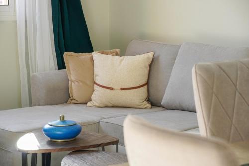 a living room with a couch with a blue pot on a table at Modern 2 bedroom apartment, one with terrace in Marrakech