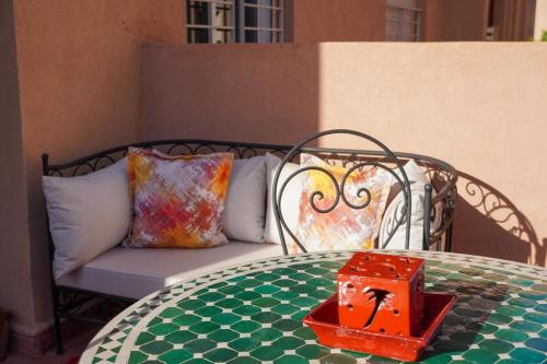 a table with a bench and a box on top of it at Modern 2 bedroom apartment, one with terrace in Marrakech