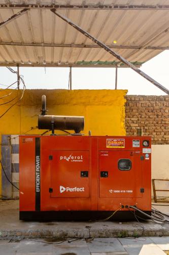 an orange machine sitting on the ground in a building at Lime Tree Hotel Vrindavan Near #BankeBihari #PremMandir #ChaarDham in Vrindāvan