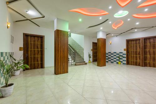 a lobby with wooden doors and a tile floor at Lime Tree Hotel Vrindavan Near #BankeBihari #PremMandir #ChaarDham in Vrindāvan