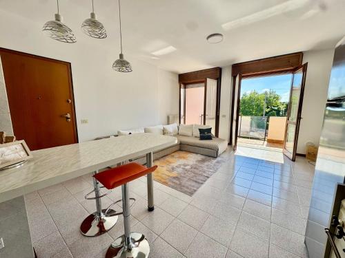 a kitchen and living room with a table and a couch at Helena home in Torre De' Roveri