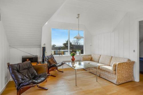 a living room with a couch and a table at 30582-Odder-Dyngby-Havvej-66 in Odder