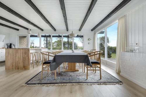 a kitchen and dining room with a table and chairs at 30582-Odder-Dyngby-Havvej-66 in Odder