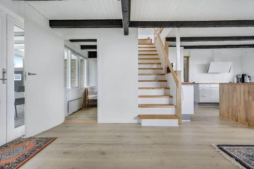 a staircase in a room with white walls and wooden floors at 30582-Odder-Dyngby-Havvej-66 in Odder