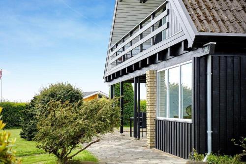 a house with a black and white facade at 30582-Odder-Dyngby-Havvej-66 in Odder