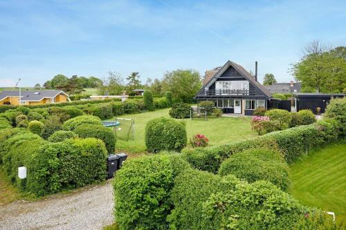 a house with hedges in front of a house at 30582-Odder-Dyngby-Havvej-66 in Odder