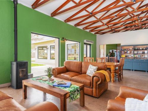 a living room with a couch and a table at Flying Ostrich Guesthouse & Self-catering Accommodation in Mariental