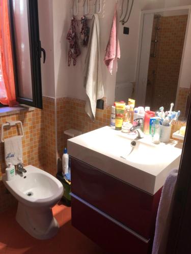a bathroom with a sink and a toilet at Villaggio 101 Pini in Buonfornello