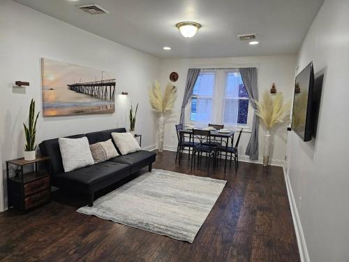 a living room with a couch and a table at Spacious 2BR Apt| 3 Beds | 15 Min to NYC in North Bergen