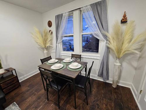 a dining room with a table and chairs and a window at Spacious 2BR Apt| 3 Beds | 15 Min to NYC in North Bergen
