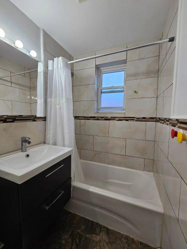 a bathroom with a tub and a sink and a shower at Spacious 2BR Apt| 3 Beds | 15 Min to NYC in North Bergen