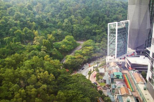 an aerial view of a city with trees and a building at Qliq Damansara Hotel in Petaling Jaya