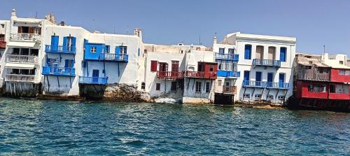 a group of buildings next to a body of water at demis Mykonos stay 2 in Platis Yialos Mykonos