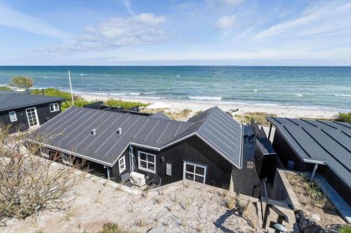 an aerial view of a black house on the beach at 30594-Odder-Toldvejen-45-H in Odder