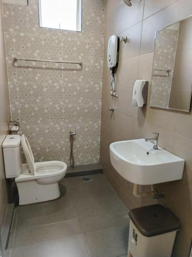 a bathroom with a toilet and a sink at Mass Boutique Hotel in Mentekab