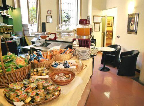 a buffet with baskets of food on a counter at Hotel Minerva in Milan