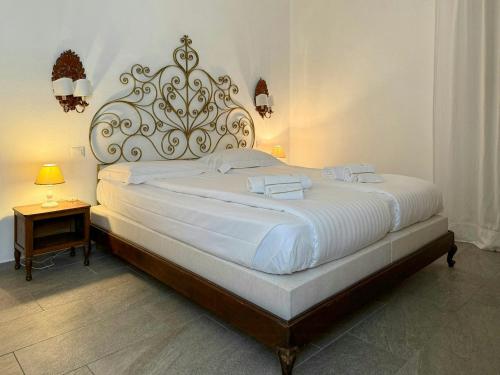 a bedroom with a large bed with a large headboard at Villa With Pool Overlooking Lake Maggiore in Gignese