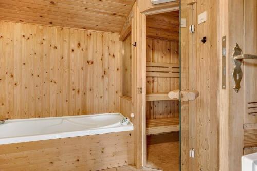 a wooden bathroom with a tub and a shower at 30069-Beder-Hogevaenget-12 in Beder