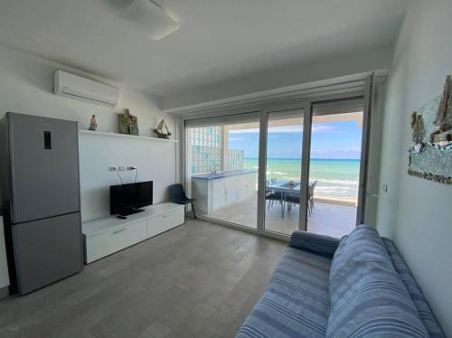 a bedroom with a bed and a view of the ocean at Acqua di Mare 108 by GGS Holiday in Termoli