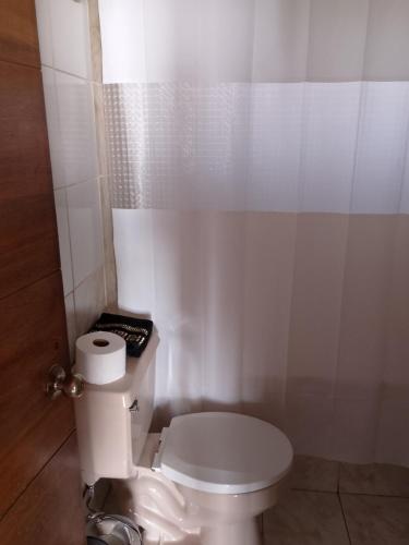 a bathroom with a white toilet in a room at Cabaña en Laguna Verde in Laguna Verde
