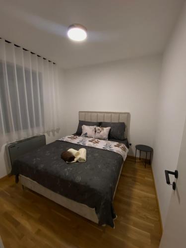 a bedroom with a bed with a stuffed animal on it at Apartman P&N Stara Pazova in Stara Pazova