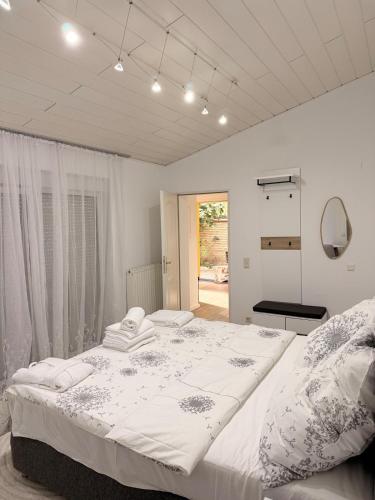 a bedroom with a large bed and a mirror at Bungalow sunshine in Weilerswist