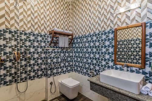 a bathroom with a toilet and a sink at Munal and Mayur Resort - Wellness Retreat Pvt Ltd in Tikoli