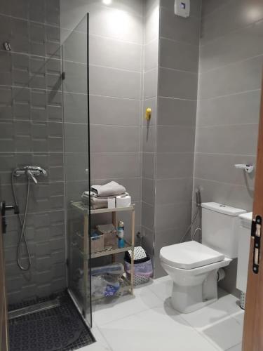 a small bathroom with a toilet and a shower at Hamza Fahim in Kenitra