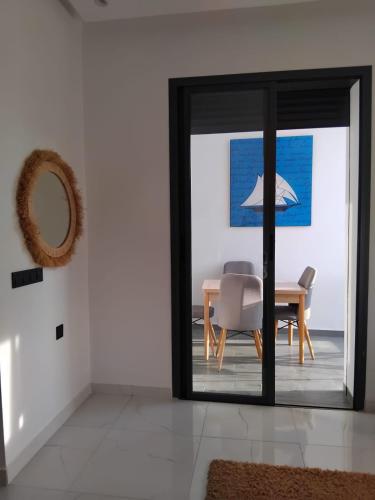 a dining room with a table and a chair at Hamza Fahim in Kenitra