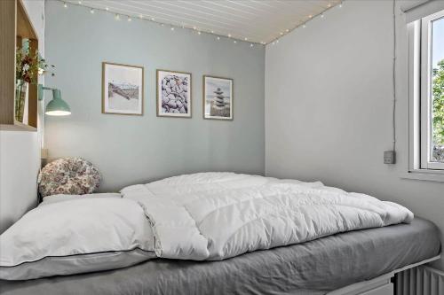 a white bedroom with a bed and a window at 40117-juelsminde-Gludvej-7 in Juelsminde
