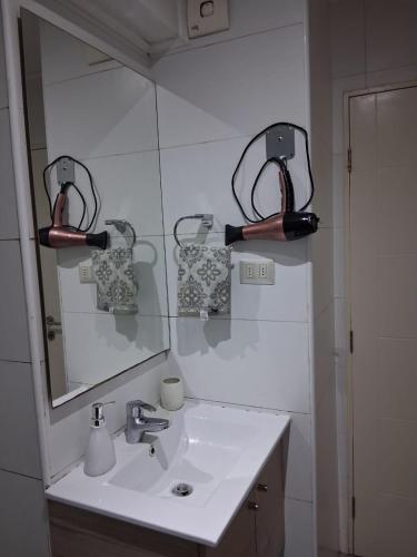 a bathroom with a sink and a mirror at Refugio de Paz y Naturaleza en Pucón in Pucón
