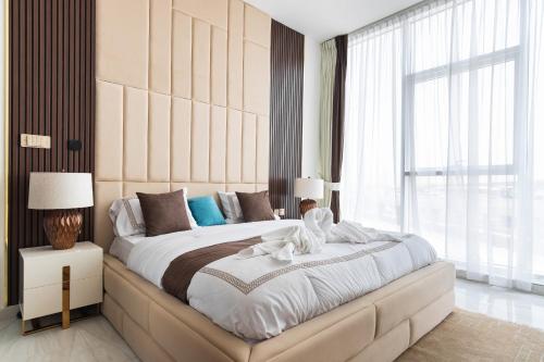 a bedroom with a large bed with a large window at Simply Comfort Vacation Homes Rental Luxury 3Br Apts with Private Pool in Gemz in Dubai