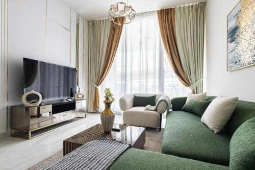 a living room with a green couch and a television at Simply Comfort Vacation Homes Rental Luxury 3Br Apts with Private Pool in Gemz in Dubai