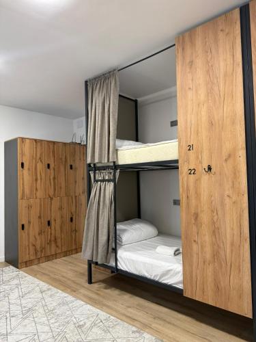 a room with two bunk beds in it at Kerege Guesthouse & Hostel in Bishkek