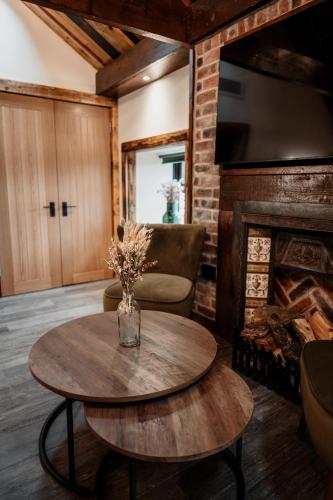 a living room with a table and a fireplace at South Causey Inn in Stanley