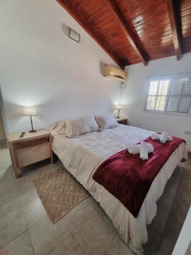 a bedroom with a large bed with two towels on it at La quinta in Esquina