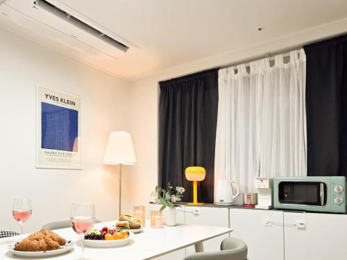 a room with a table with food and wine glasses at STYLEINN#NewlyBuilt#IKEA #KSPO #AsanHospital #12PMCheckOut in Seoul