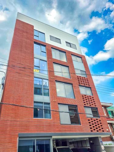 a tall red brick building with many windows at STYLEINN#NewlyBuilt#IKEA #KSPO #AsanHospital #12PMCheckOut in Seoul