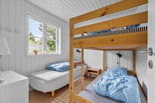a bedroom with a bunk bed and a bed and a desk at 40385-Juelsminde-Firkanten-5 in Sønderby