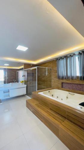 a large bathroom with a large tub in a room at Casa Grande Angra de Ipioca in Maceió