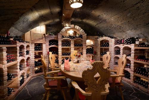 a room with a table with bottles of wine at Hotel Neue Post in Mayrhofen