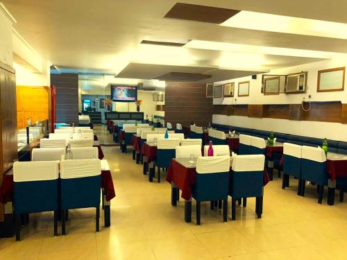 a dining room filled with tables and chairs at Hotel Yuvraj Dx in Pipra Dewās