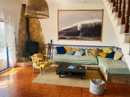 a living room with a couch and a table at Santa Cruz Surf House by Stoke Travel in A dos Cunhados