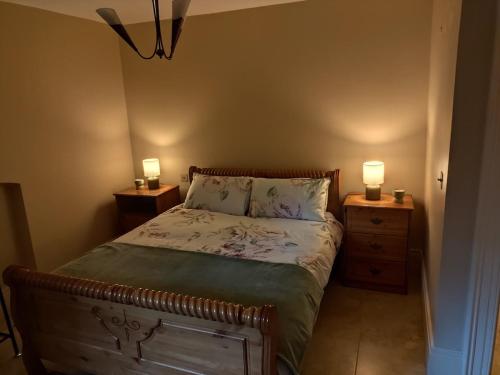 a bedroom with a bed with two night stands and two lamps at Charlesfort House in Ferns