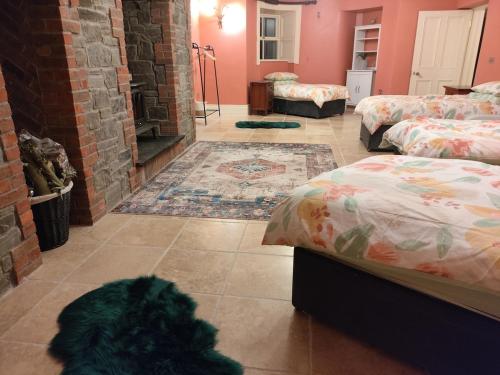 a room with two beds and a tile floor at Charlesfort House in Ferns